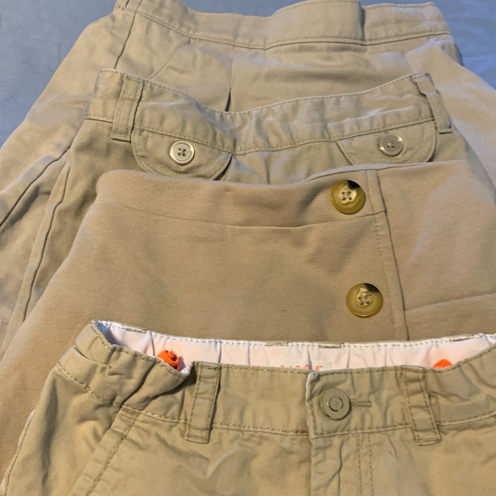 4 uniform bottoms, 1 short, 3 skirts in good condition, no stains